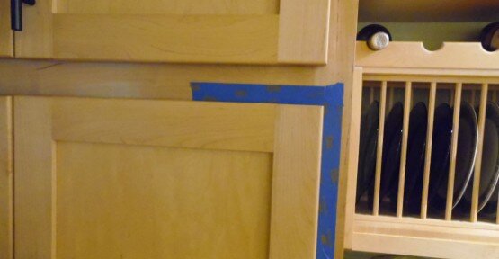 Using blue painters tape to measure your cabinet door overlay